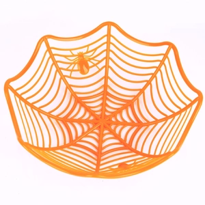 Orange spider web fruit bowl with plastic decorative spiders for Halloween party table
