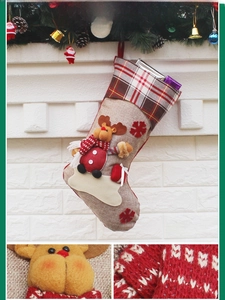 Detail of Christmas stocking featuring 3D reindeer applique and red snowflake embroidery