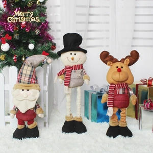 Three telescopic Christmas plush dolls featuring Santa, Snowman and Reindeer on display