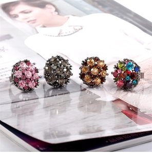 Macro detail of vintage floral rings set with colorful crystals and alloy base