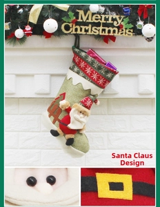 Detail of green burlap Christmas stocking with plush Santa and red snowflake embroidery