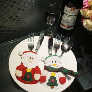Christmas silverware holders featuring Santa and snowman embroidery on white ceramic plate