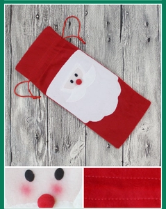 Macro view of Santa Claus wine bottle bag detailing fabric texture and precise stitching