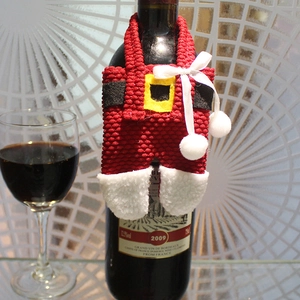 Christmas Santa pants wine bottle cover made of red knit fabric with plush white trim