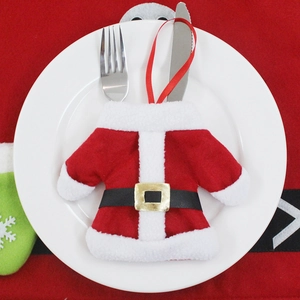 Christmas Santa suit cutlery holder on white plate with silver knife and fork