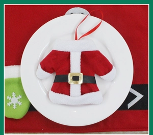 Mini Santa top cutlery holder with gold buckle on a plate for Christmas table decor
