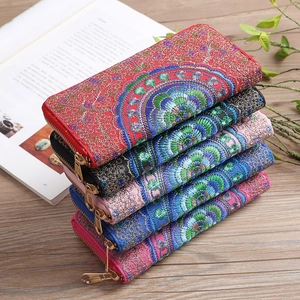 Detailed stack of five ethnic embroidered long wallets showing colorful floral patterns