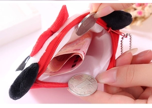 Close-up of small plush coin purse interior showing storage capacity and zipper detail