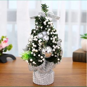Detailed close-up of a 20cm mini Christmas tree with silver balls and white berries