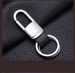 Close-up of heart photo keychain with silver metal hook and premium black leather strap