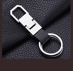 Close-up of black leather car keychain with silver metal buckle and double key rings