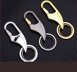 Close-up of heart-shaped photo frame keychains in silver, gunmetal, and gold metal finish