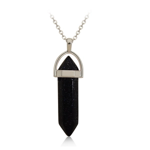 Macro shot of blue sandstone hexagonal crystal point pendant on a silver metal chain