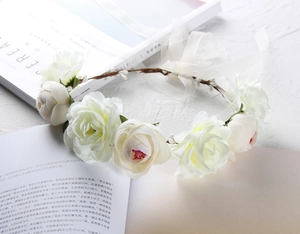 Detailed view of white faux rose flower headband with delicate organza ribbon ties