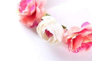 Close-up of bohemian bridal floral crown with pink and white gradient silk flower petals