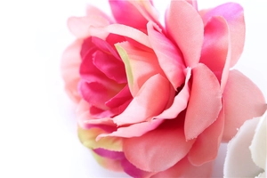 Macro detail of bohemian fabric flower petals with pink and peach color gradients
