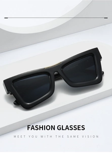 Detail of black rectangle sunglasses featuring a decorative gold chain element on the frame