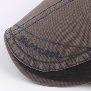 Brown cotton newsboy cap with embroidered letters and textured twill fabric detail