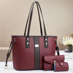 Three-piece burgundy leather tote bag set with textured finish and gold-tone hardware
