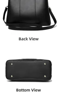 Detail view of black leather tote bag back and bottom with protective gold studs