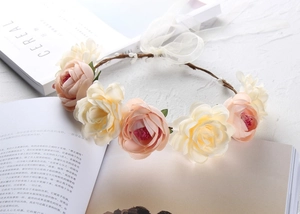 Detail of cream and salmon floral wreath crown with brown twig base and ribbon