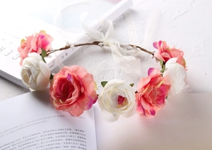Detail of pink and white rose flower crown on an open book with adjustable ribbons