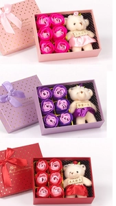 Detail of soap rose gift box featuring six roses and a plush bear with golden ribbon