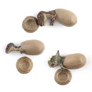 Set of 3 hatching dinosaur egg models including T-Rex and Triceratops with rock bases