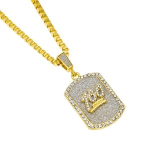 Close-up of gold dog tag pendant with 100 numeric design and rhinestone border