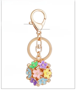 Detail of colorful enamel flower keychain with golden alloy ring and lobster clasp