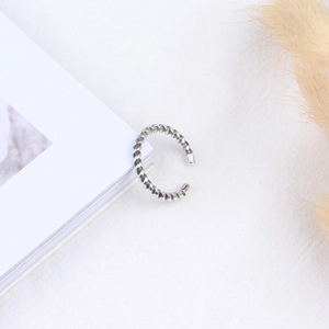 Retro twisted rope pattern open ring in S925 sterling silver style on white fabric