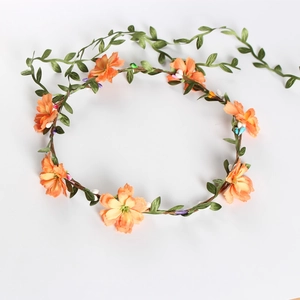 Floral bridal wreath with orange flowers and green leaves for wedding or beach vacations