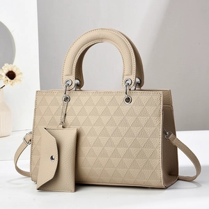 Detailed view of beige tote bag with geometric triangle embossing and mini envelope pouch