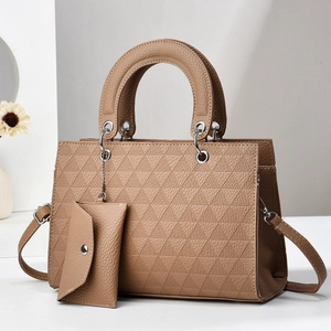 Detail of khaki tote bag with geometric triangle texture and matching small pouch charm