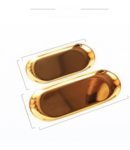 Macro detail of oval gold stainless steel jewelry trays in large and small sizes