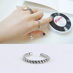 Vintage braided S925 sterling silver open ring shown on hand and white background