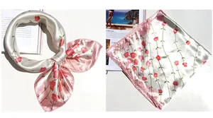 Detailed view of pink floral silk scarf with vintage rose print and soft satin texture
