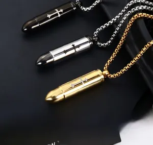 Detailed close-up of bullet-shaped cross pendants in silver, gold, and gunmetal finishes