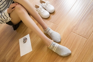 Cute low cut cotton cat socks with 3D ears and stripes shown in a cozy home setting