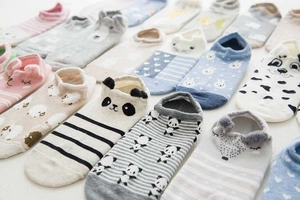 Flat lay of colorful Japanese style cotton socks with assorted cute 3D cartoon animal patterns