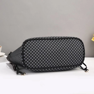 Detail view of large tote bag bottom with black and white geometric cross pattern