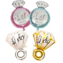 Detailed view of four ring-shaped foil balloons with I do and Marry You text