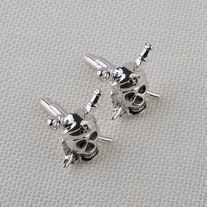 Detailed close-up of pirate skull and crossbones cufflinks in silver metal finish