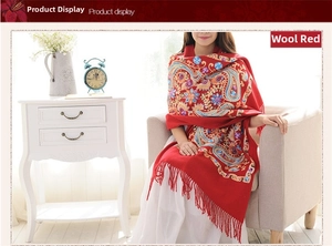 Detailed embroidery view of ethnic red wool shawl with paisley patterns and fringe