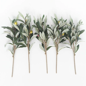 Detailed view of four artificial olive branches with realistic green leaves and fruits