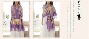 Detailed close-up of purple wool shawl with ethnic embroidery and elegant tassel fringe
