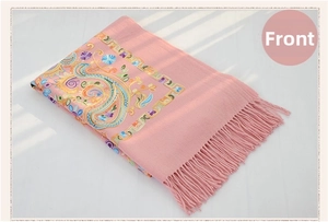 Detail of pink wool shawl featuring ethnic paisley embroidery and elegant fringe edges