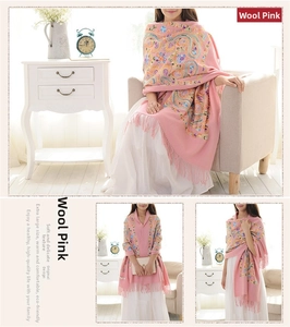 Detailed embroidery on pink wool shawl with floral paisley patterns and long fringes