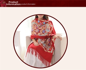 Detailed embroidery of red wool shawl with paisley patterns and handmade tassels