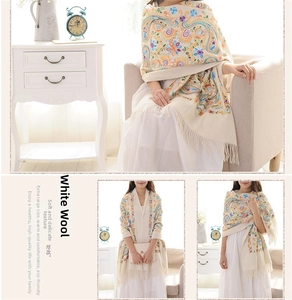 Close-up of wool white shawl featuring intricate colorful paisley and floral embroidery detail